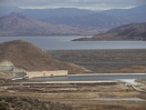 Looking over the west dam of a 3/4 filled lake